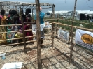 Beneficiary women waiting to receive their shelter reinforcement materials._1